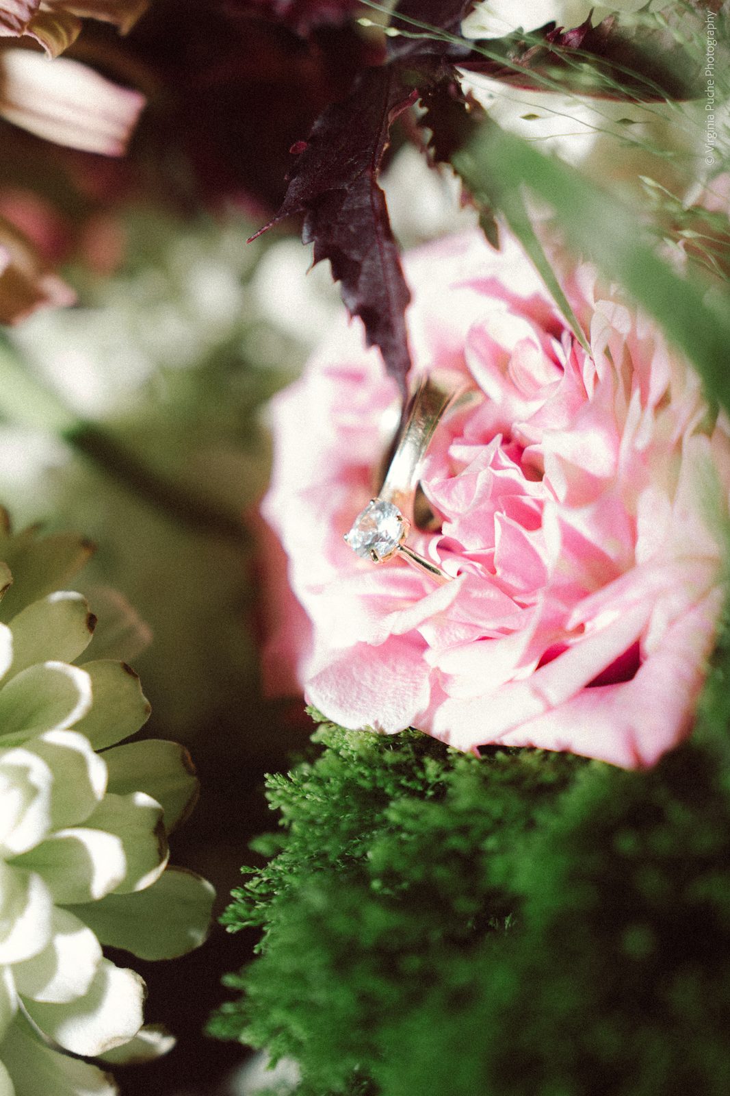 Engagement ring resting on pink florals at a Memphis wedding
